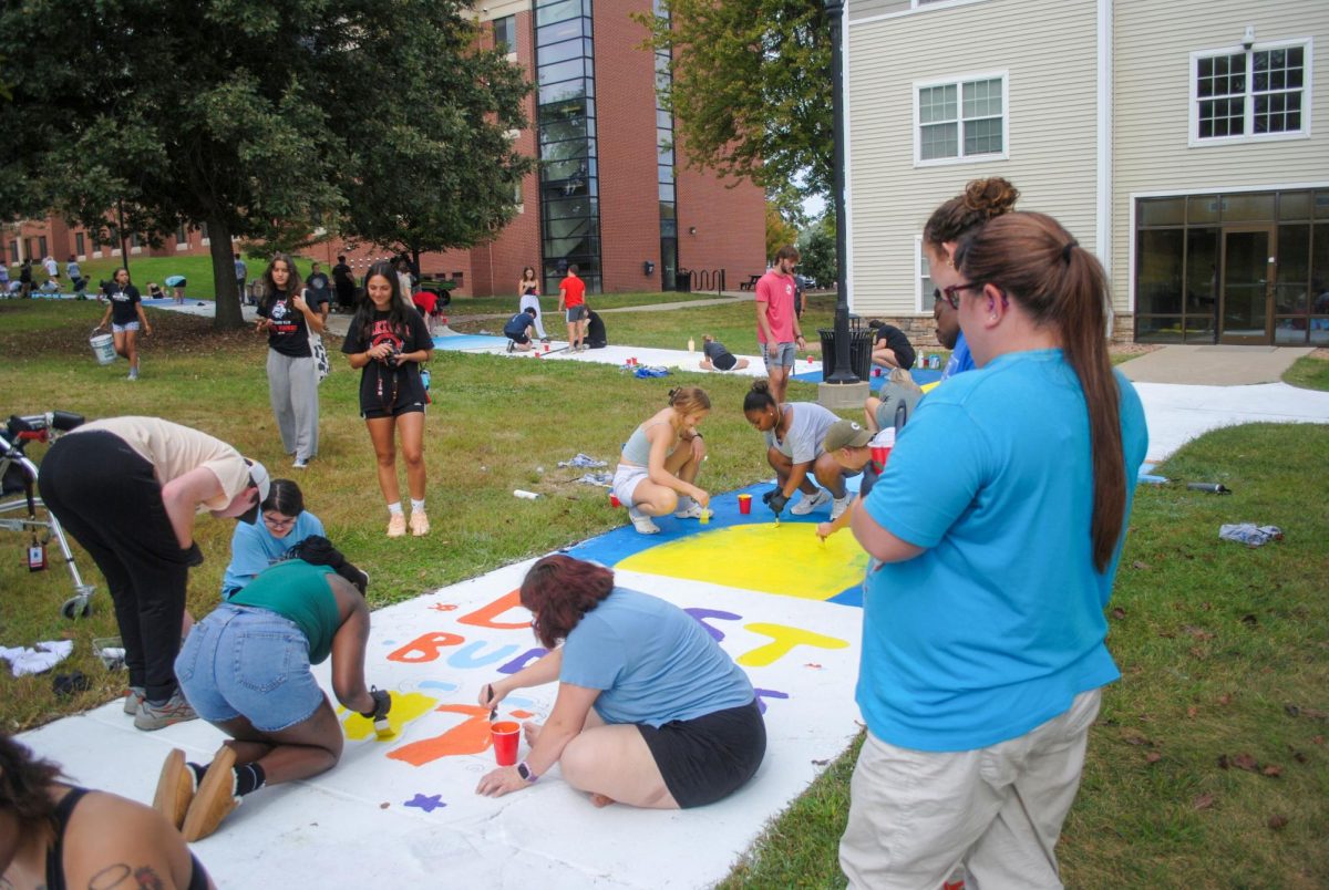 Students paint the sidewalk for Homecoming week at Grand View University on Sunday, September 21, 2025 
