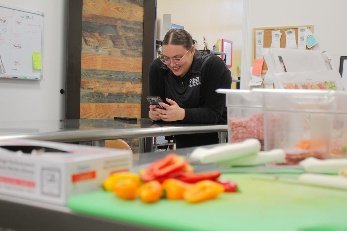 Jordan Lipinski giggles at a a Tik Tok reel she filmed at Graze Craze Charcuterie Boards & Boxes in Urbandale, Iowa on Thursday, November 20, 2025.

Charlee Heffron