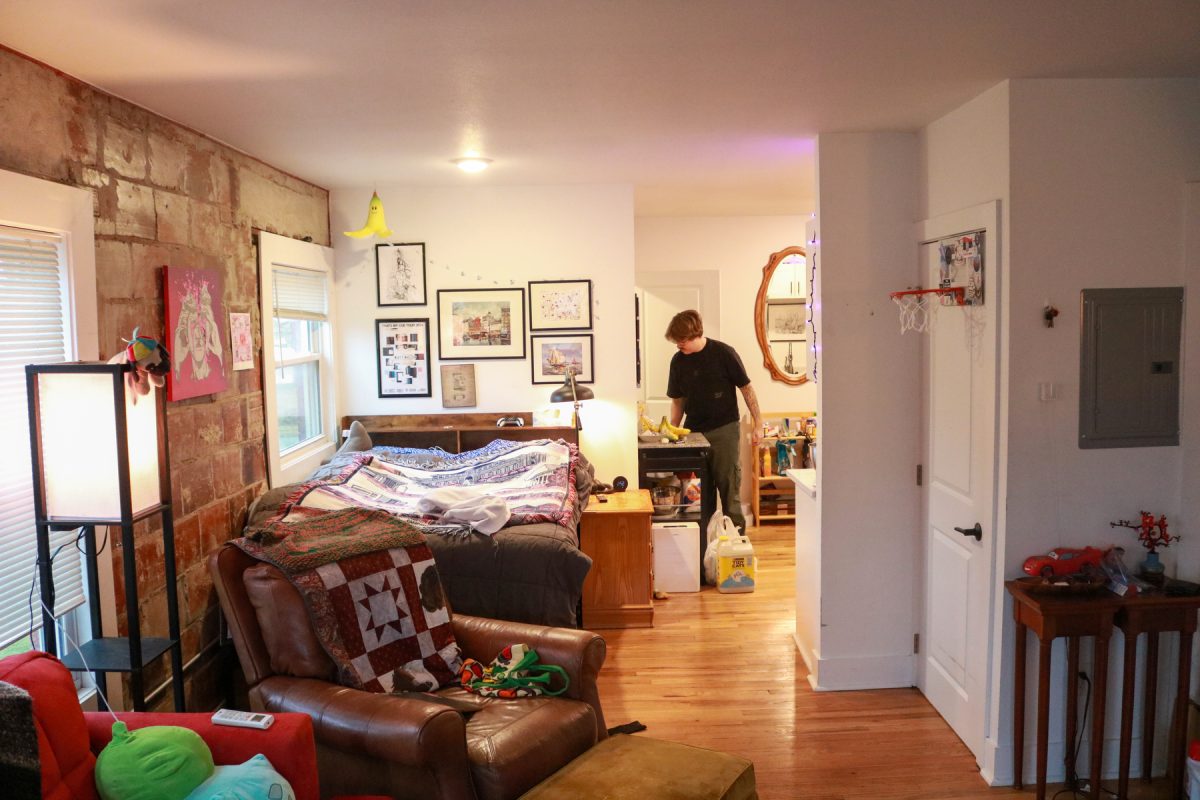 Milos Garton puts away groceries in his studio apartment in Highland Park, Iowa on Wednesday, November 19, 2025.