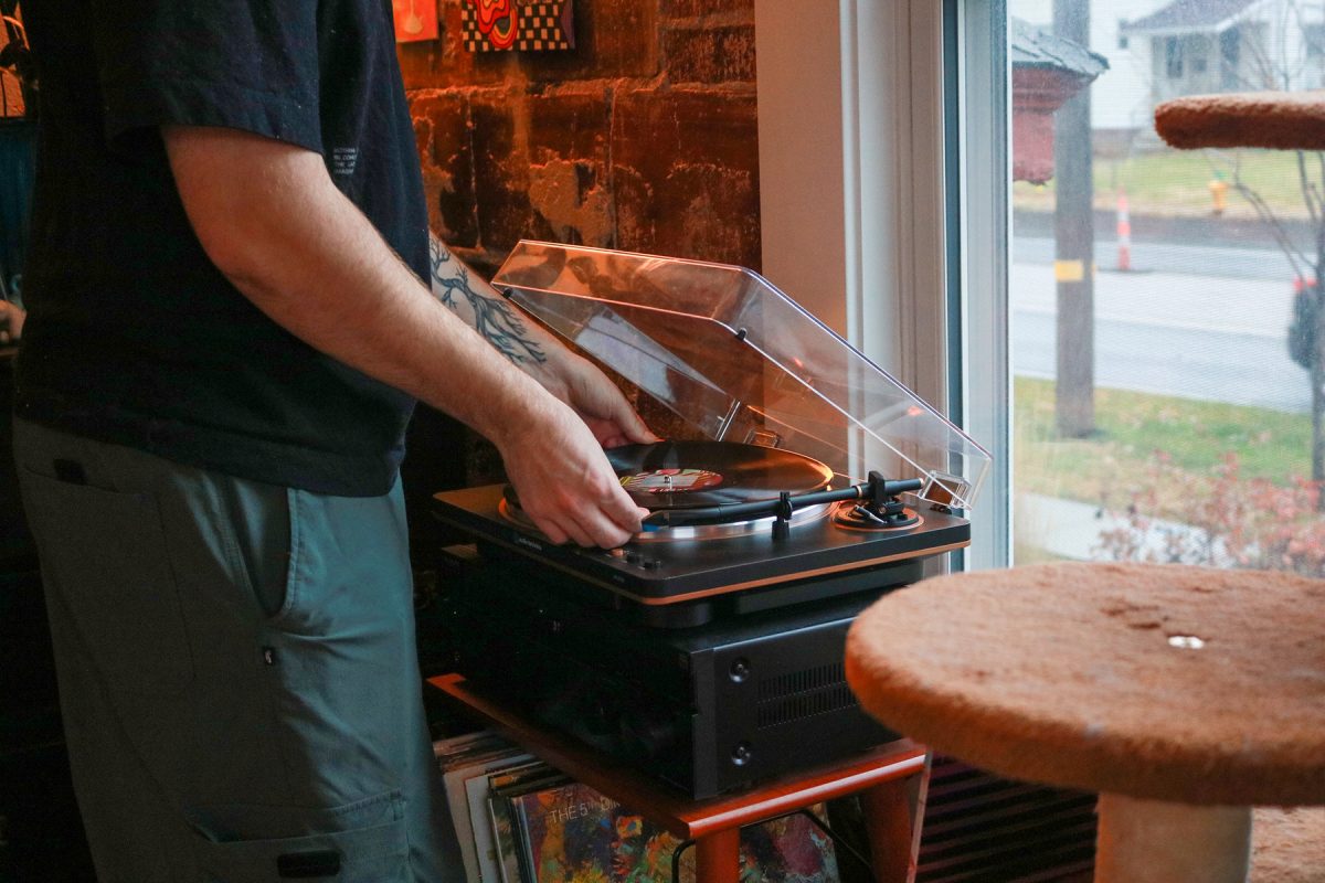 Milos Garton sets a record onto his record player in his studio apartment in Highland Park, Iowa on Wednesday, November 19, 2025.

Garton often will put a record on as he cooks.