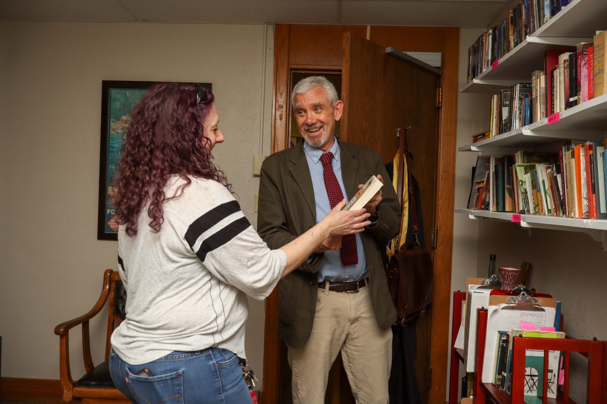 Steve Snyder and a past student converse over a book in his office at his retirement book call at Grand View University in Des Moines, Iowa on Wednesday, April 8, 2026

Kylie Arai